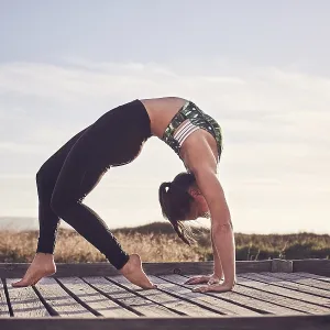 Young woman, yoga, gymnastics on the beach