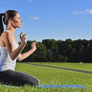 Young woman during yoga meditation in the park Young woman during yoga meditation in the park