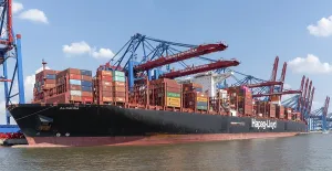 08-16-2020 Hamburg, Germany: Large container ship and container gantry cranes in port of Hamburg