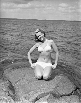 1940s bikinifashion. A swedish young woman in a white bikini on a summer's day