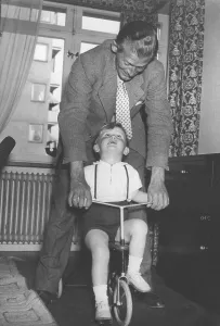 1940s father and son with a tricycle