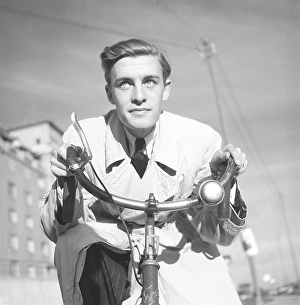 1940s man on a bicycle. The Swedish actor Alf Kjellin on a bicycle holding the handlebars