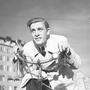 1940s man on a bicycle. The Swedish actor Alf Kjellin on a bicycle holding the handlebars. Sweden 1940. Photo Kristoffersson 157-6