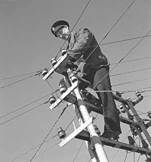 In the 1940s. A man is seen climbing on top of an electrical pole with power wires