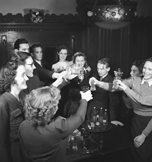 In the 1940s. A non-alcohol toast with young people raising their glasses in celebration with just soda in them