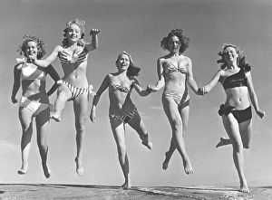 1940s summer. A group of young women in their bikinis are happy on this summer's day