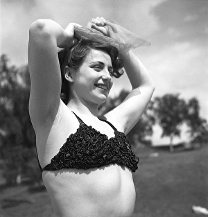 1940s summer. A young woman in a bikini top