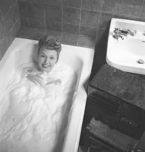 1940s woman in the bathtub. A young woman is having a nice warm bath