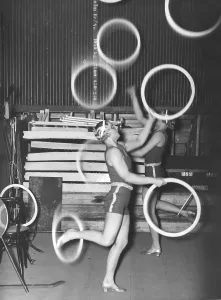 In the 1940s. Two women are seen juggling and balancing rings at the same time while standing on one leg only. Sweden 1946 Kristoffersson ref T68-4