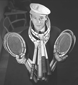 In the 1940s. A young man in a cap stands and holds the tennis racket in his hands