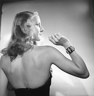 In the 1940s. A young woman wearing a bracelet visible on the arm