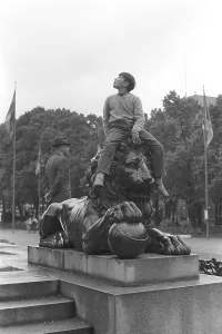 In the 1950s. A boy is sitting on top of a statue of a lion in Kungstraedgarden Stockholm Sweden 1953 Kristoffersson