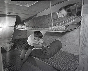 1950s camping. A family is enjoying their holiday and the practial camping life in their caravan