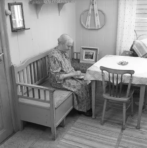 In the 1950s. An elderly lady is seen in her kitchen