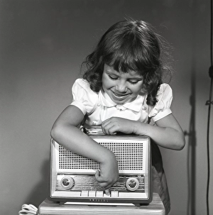 In the 1950s. A girl with a Philips radio set