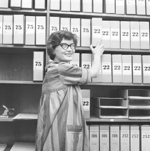 1950s glasses. A young woman in glasses and bows August 1959 is working in an archive