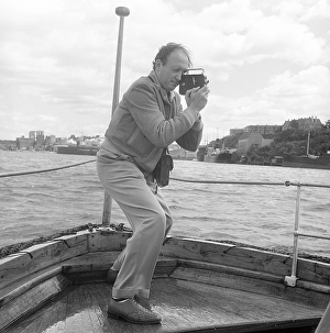 In the 1950s. A man is filming with a amateur film camera
