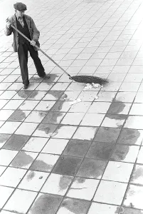 In the 1950s. A man is working outdoors sweeping the rubbish and trash from the street. Sweden 1953. ref 2A-25