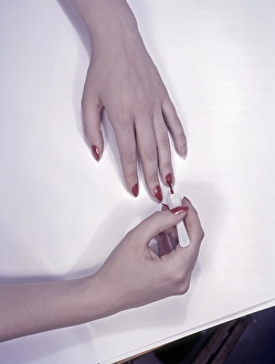 1950s nails. A woman is painting her nails red. Sweden 1950s