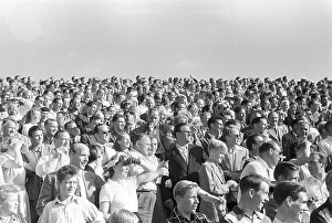In the 1950s. The stand is full of people watching an ongoing football match at an outdoor stadium in Stockholm Sweden 1953. Kristoffersson ref 1-41-1