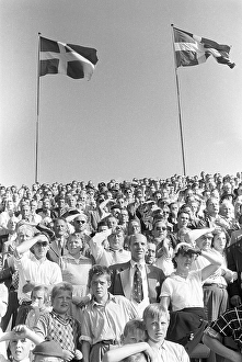 In the 1950s. The stand is full of people watching an ongoing football match at an outdoor stadium in Stockholm Sweden