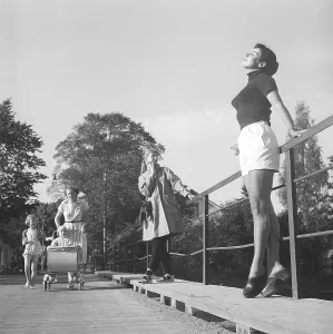 1950s summer. While a young woman wearing shorts