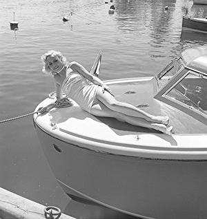 1950s swimsuit fashion. A swedish young woman in a bathing suit on a summer's day