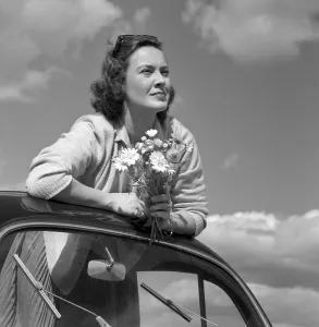 In the 1960s. Actress Gaby Stenberg looks happy this summer day having the top off her Volkswagen beetle car
