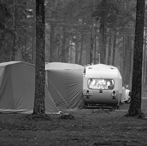 1960s camping. A family is enjoying their holiday and the practial camping life in their caravan