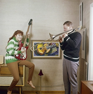 In the 1960s. A couple is seen playing the trombone and an electric guitar