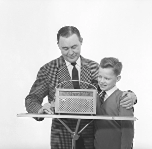 In the 1960s. Father and son with a radio