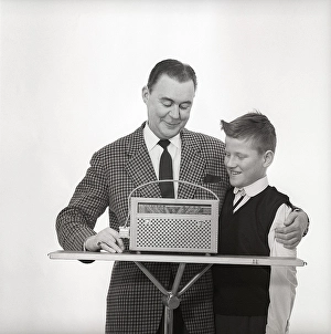 In the 1960s. Father and son with a radio