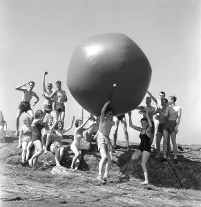 1960s fun in the sun. A group of teenagers play on this sunny day