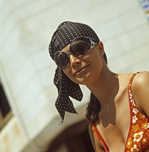 1960s glasses. Summer of 69. The young female fashion model is wearing this years model of sunglasses and accessories