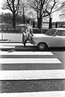In the 1960s. A moment when a man walks on a pedestrian crossing but a car has not noticed him and keeps driving. The man jumps away from the car to avoid being hit by it. Sweden 1968. Kristoffersson ref 3-57