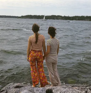 1960s parents. Two women holding hands