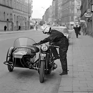 In the 1960s. A woman seen dressed in the typical motorcycle drivers outfit