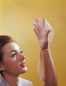 In the 1960s. A young woman with a stocking on her hand and arm