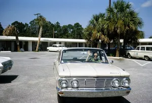 1963 Mercury Comet automobile, Florida, USA in 1963 female driver waving