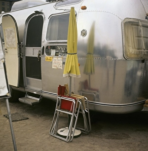 1970s camping. Pictured an American Airstream caravan in aluminium and in the typical 1930s streamline design