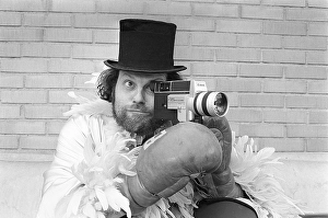 In the 1970s. A man is filming with a amateur film camera