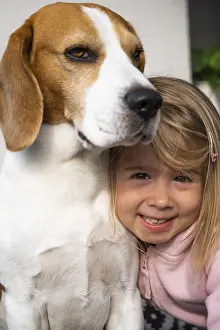2 year old child hugging best friend dog