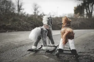 Abandoned rocking horses on the road