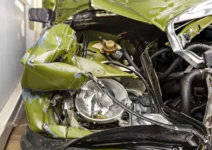 Accident, Car crash collision. Closeup shot of a crashed oldtimer cars front with demolished headlight