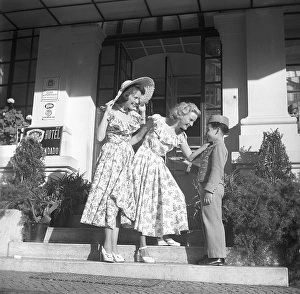 The actresses in Lisbon, Portugal, 1949. Gaby Stenberg (1923-2011) with Margareta Fahlen (1918-1978) in front of a hotel with a bellboy they seem to like very much
