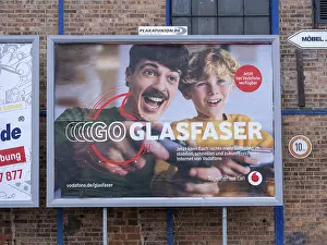 Advertising poster for fibre optics from Vodafone on the wall of an industrial building