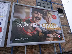 Advertising poster for fibre optics from Vodafone on the wall of an industrial building