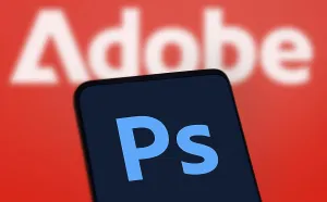 Adobe photoshop logo is displayed on smartphone