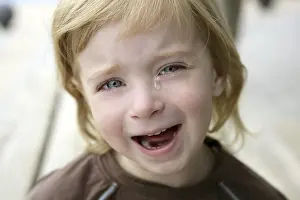 Adorable blond little girl crying closeup portrait