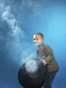 Adorable boy posing in cloud of steam